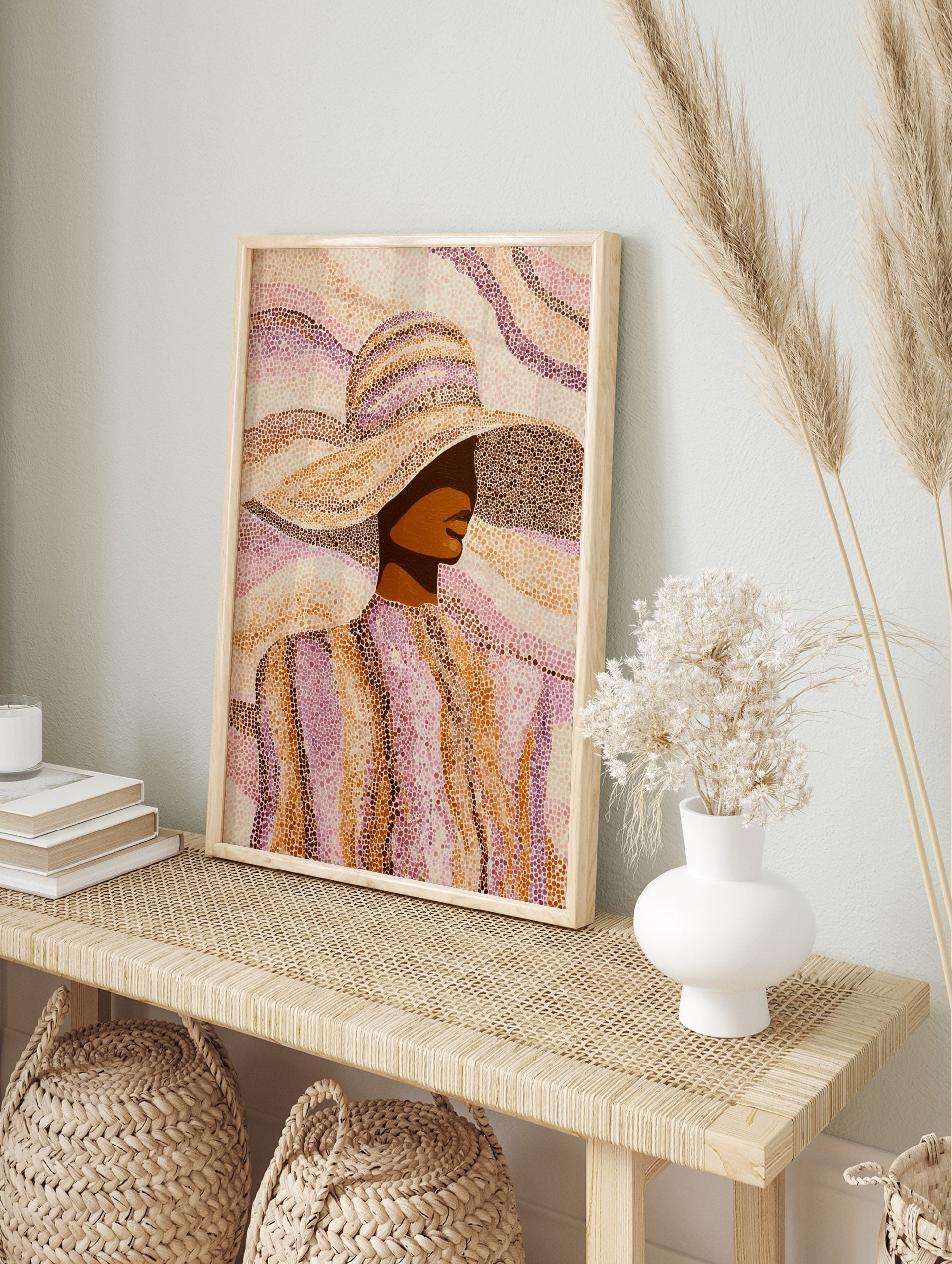 Pointillist art print of a woman in a wide-brimmed hat, rendered in brown, orange, and pink, in an alternate framed mockup