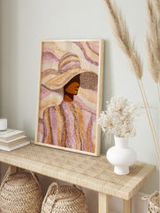 Pointillist art print of a woman in a wide-brimmed hat, rendered in brown, orange, and pink, in an alternate framed mockup