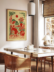 Illustrative print of a woman in a hat reading by the sea with red sun and potted flowers in red, in a styled room mockup
