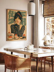 Retro illustrative wall art showing a woman with a red headband and polka dot top surrounded by, in a styled room mockup