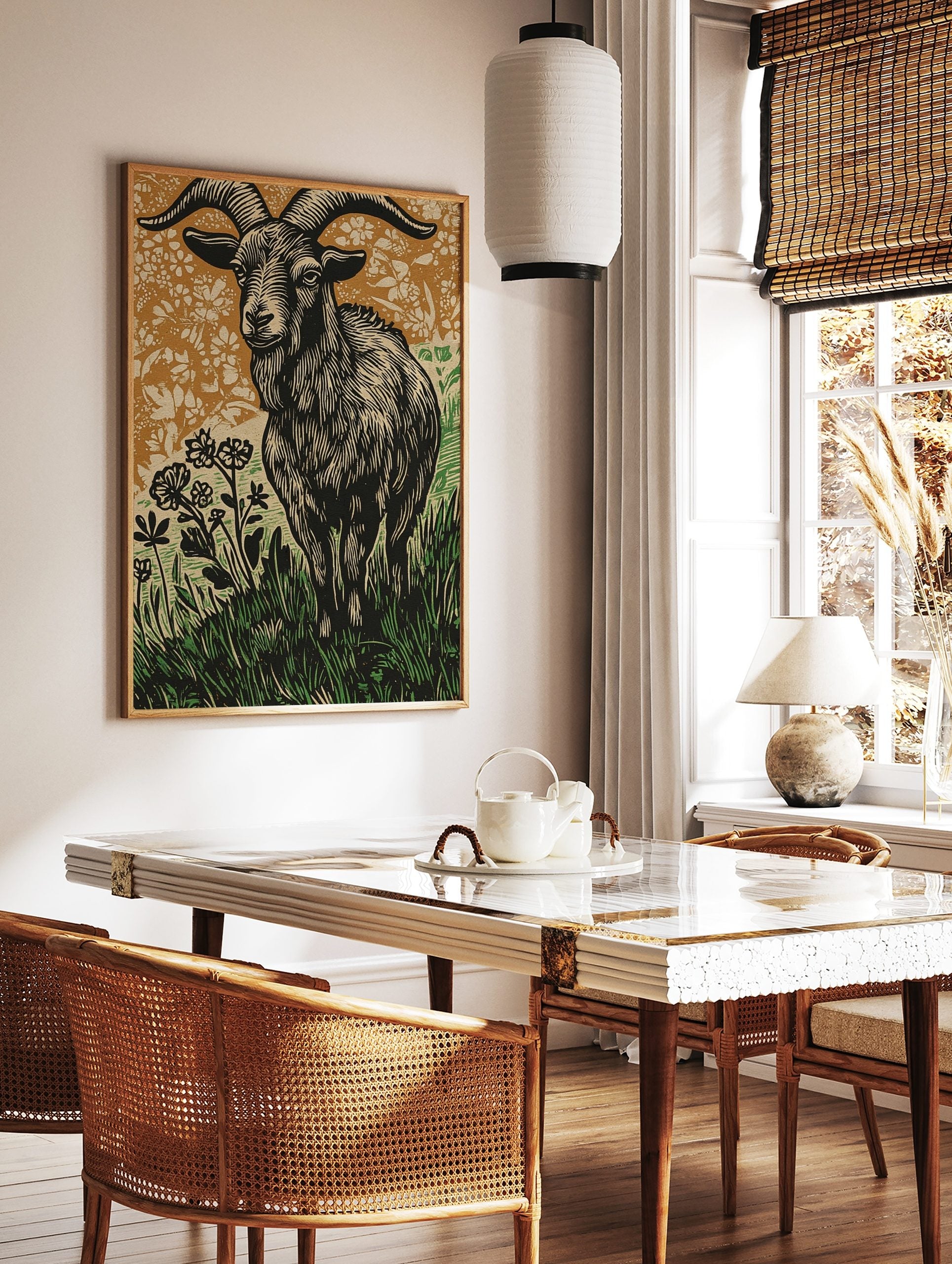 Woodcut style print of a ram goat with large horns in grass and flowers, brown and green background, in a styled room mockup