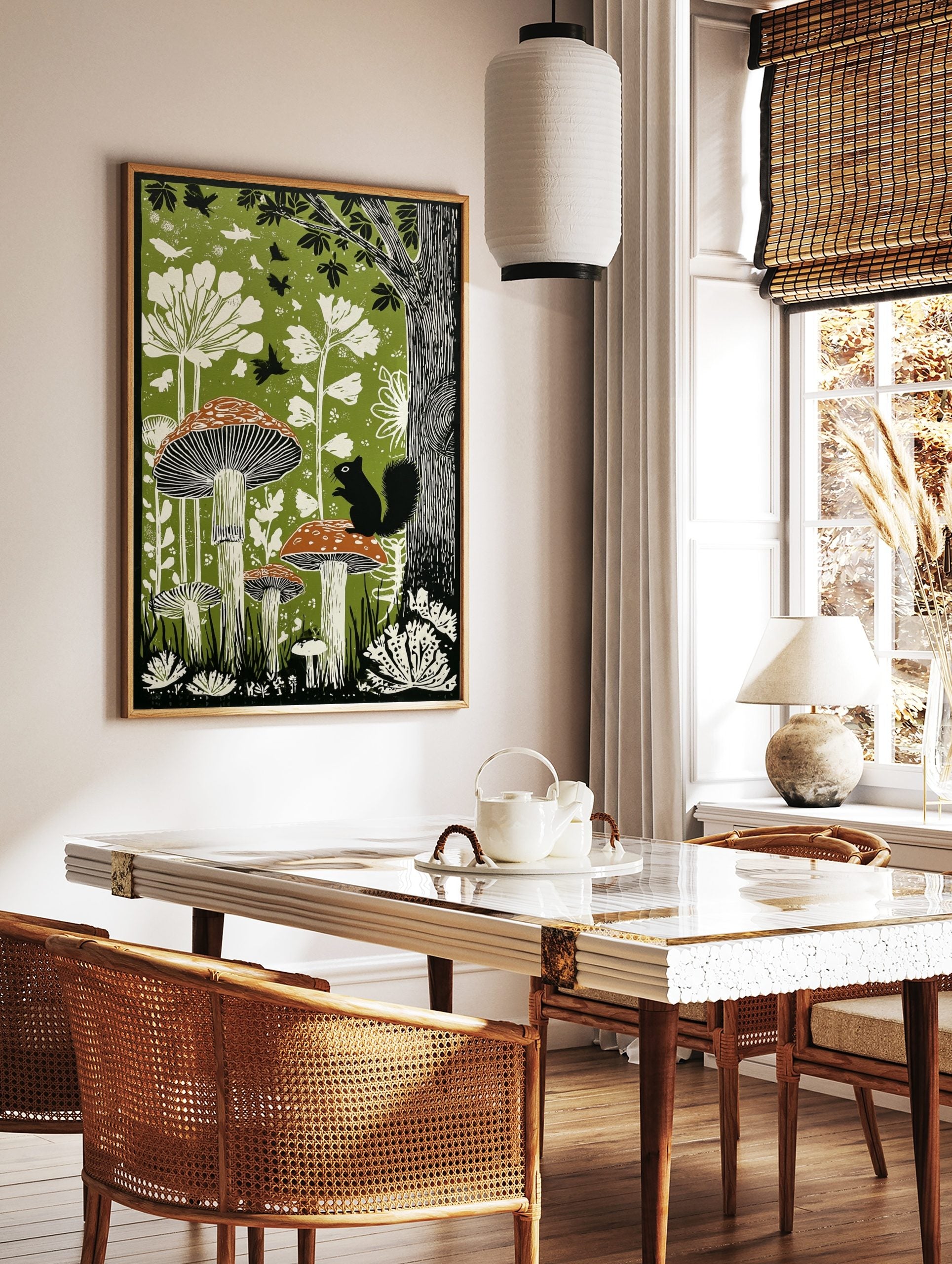 Illustrative woodland art print with large mushrooms, a black squirrel, white plants, and birds on, in a styled room mockup