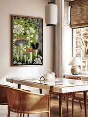 Illustrative woodland art print with large mushrooms, a black squirrel, white plants, and birds on, in a styled room mockup