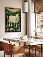 Illustrative print of a woolly sheep surrounded by wildflowers and green hills under a striped sky, in a styled room mockup