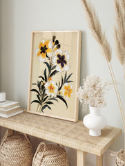 Botanical illustration of yellow flowers with dark leaves on a cream background, floral wall, in an alternate framed mockup