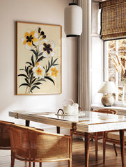 Botanical illustration of yellow flowers with dark leaves on a cream background, floral wall art, in a styled room mockup