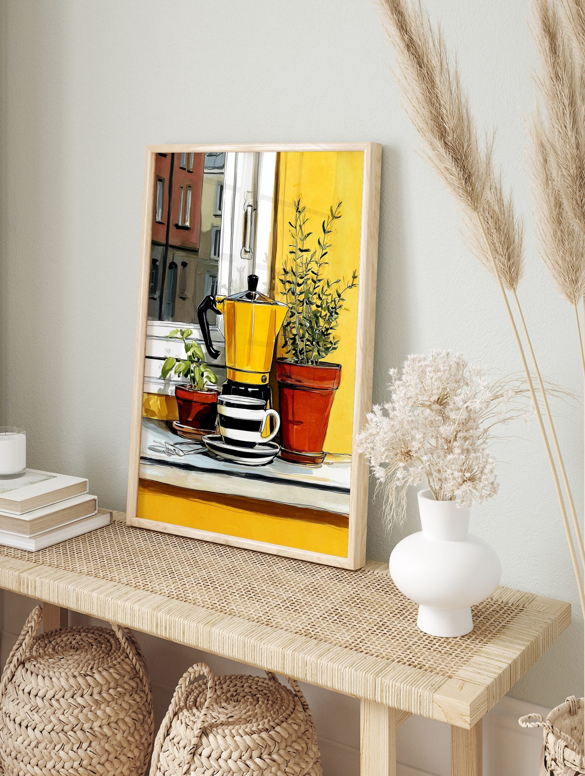Illustrative print of a yellow moka pot and striped coffee cup with potted green plants on a, in an alternate framed mockup