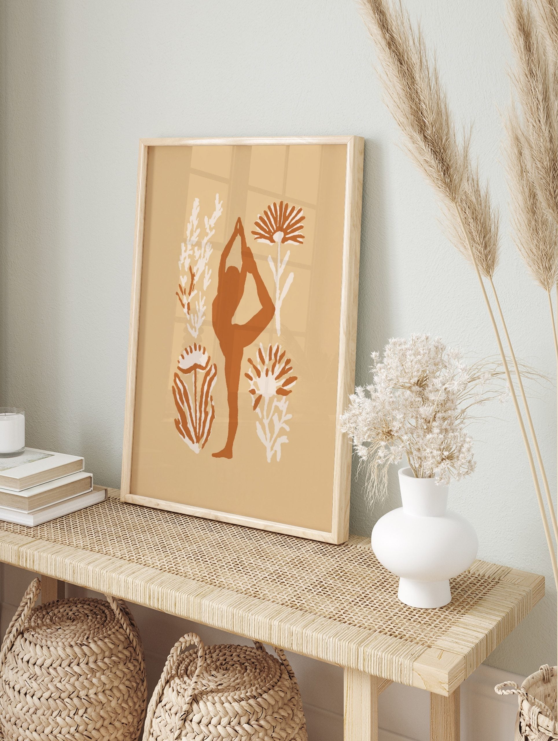 Terracotta yoga dancer pose silhouette with cream botanical illustrations on a beige, in an alternate framed mockup