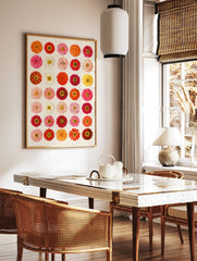 Botanical grid art print featuring thirty colourful zinnia flowers in red, orange, pink, and yellow, in a styled room mockup