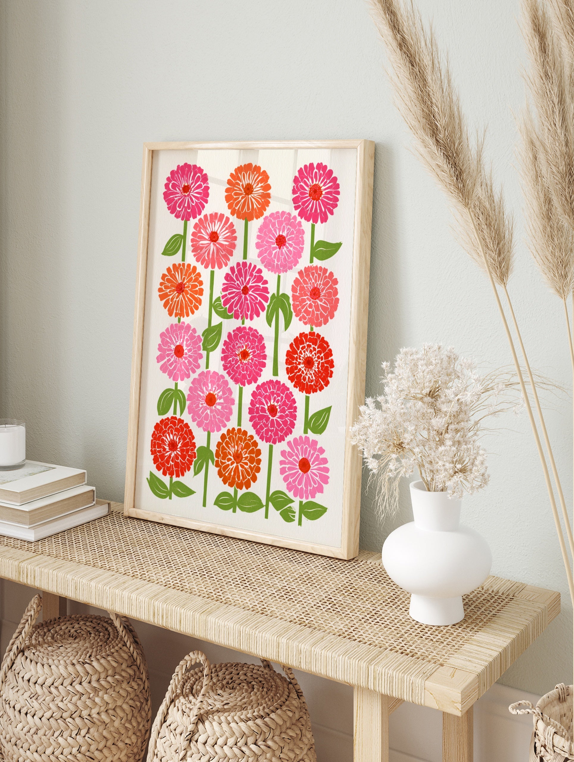 Botanical zinnia flower illustration in pink, orange, and red with green stems on a cream, in an alternate framed mockup